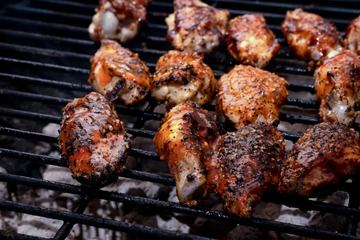Barbecued Buffalo Chicken Wings on a Grill.