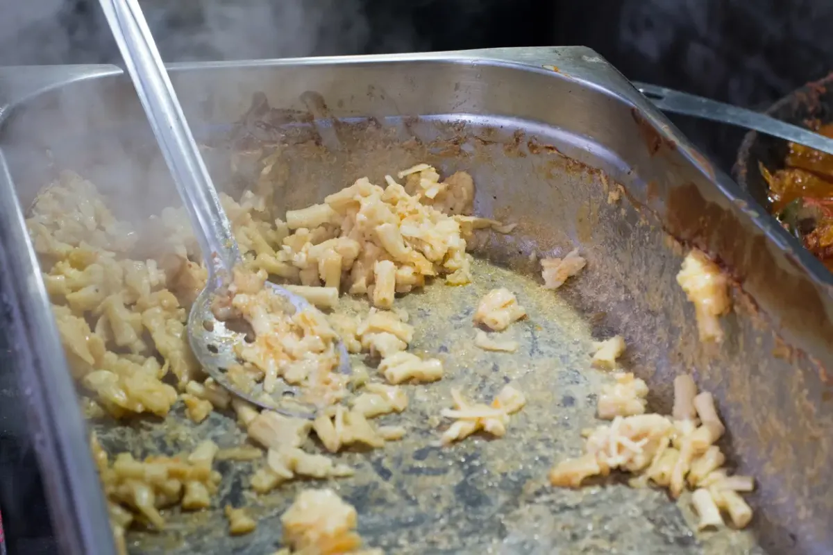 Empty catering dish that used to be full of Macaroni and Cheese.
