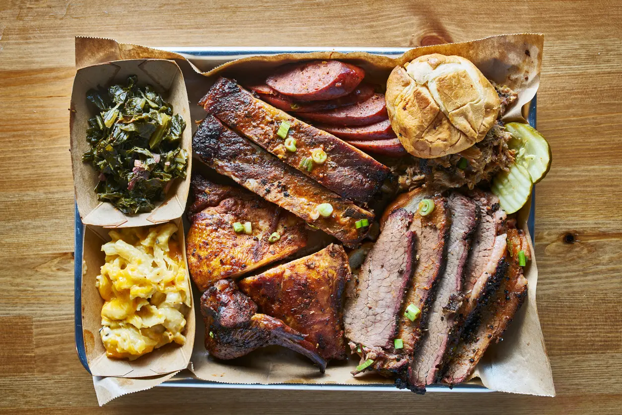 BBQ tray with smoked beef brisket, ribs, chicken and hot links. 